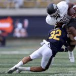 
              UNLV running back Aidan Robbins (9) is tackled by California safety Daniel Scott (32) during the second half of an NCAA college football game in Berkeley, Calif., Saturday, Sept. 10, 2022. (AP Photo/Jed Jacobsohn)
            