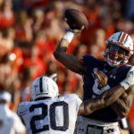 
              Auburn quarterback Robby Ashford (9) is hit by Penn State defensive end Adisa Isaac (20) as he throws the ball during the second half of an NCAA college football game, Saturday, Sept. 17, 2022, in Auburn, Ala. (AP Photo/Butch Dill)
            