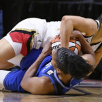 
              Las Vegas Aces' Kelsey Plum, top, and Connecticut Sun's Alyssa Thomas fight for possession of the ball during the second half in Game 4 of a WNBA basketball final playoff series, Sunday, Sept. 18, 2022, in Uncasville, Conn. (AP Photo/Jessica Hill)
            