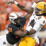 
              Oklahoma State defensive end Collin Oliver (30) collides with Arizona State quarterback Emory Jones (5) after he attempts a pass during an NCAA college football game, Saturday, Sept. 10, 2022, in Stillwater, Okla. (Ian Maule/Tulsa World via AP)
            