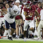 
              Alabama quarterback Bryce Young, front right, runs with the ball against Utah State defensive lineman Hale Motu'apuaka (8) during the first half of an NCAA college football game Saturday, Sept. 3, 2022, in Tuscaloosa, Ala. (AP Photo/Vasha Hunt)
            