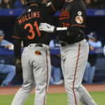 
              Baltimore Orioles' Adley Rutschman, right, celebrates his two-run home run against the Toronto Blue Jays with Cedric Mullins during the fourth inning of a baseball game Friday, Sept. 16, 2022, in Toronto. (Jon Blacker/The Canadian Press via AP)
            