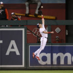 
              Washington Nationals right fielder Lane Thomas leaps up to make a catch on a fly ball hit by Atlanta Braves' Eddie Rosario for an out during the fourth inning of a baseball game, Monday, Sept. 26, 2022, in Washington. (AP Photo/Nick Wass)
            