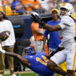 
              Pittsburgh wide receiver Konata Mumpfield (14) can't make the catch as Tennessee defensive back Tamarion McDonald (12) defends during the first half of an NCAA college football game, Saturday, Sept. 10, 2022, in Pittsburgh. McDonald was called for pass interference on the play. (AP Photo/Keith Srakocic)
            