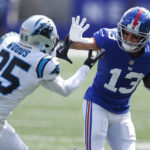 
              New York Giants' David Sills V, right, fends off Carolina Panthers' Xavier Woods during the first half an NFL football game, Sunday, Sept. 18, 2022, in East Rutherford, N.J. (AP Photo/Noah K. Murray)
            