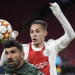 
              FILE - Sporting's Ricardo Esgaio, left, and Ajax's Antony jump for the ball during a Champions League group C soccer match between Ajax and Sporting CP, at the at the Johan Cruyff ArenA in Amsterdam, Netherlands, on Dec. 7, 2021. Brazil winger Antony looks set to complete a move to Manchester United for $95 million and join Lisandro Martinez in making a big-money switch from Dutch club Ajax to the English giant in this transfer window. (AP Photo/Peter Dejong, File)
            