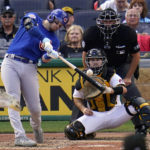 
              Chicago Cubs' Ian Happ, left, singles off Pittsburgh Pirates relief pitcher Duane Underwood Jr., driving in a run, during the seventh inning of a baseball game in Pittsburgh, Sunday, Sept. 25, 2022. (AP Photo/Gene J. Puskar)
            