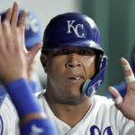 
              Kansas City Royals' Salvador Perez celebrates in the dugout after scoring on a single by Edward Olivares during the third inning of a baseball game against the Minnesota Twins Wednesday, Sept. 21, 2022, in Kansas City, Mo. (AP Photo/Charlie Riedel)
            