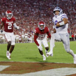 
              Kansas State quarterback Adrian Martinez (9) carries the ball for a touchdown past Oklahoma defensive lineman Jonah Laulu (8), left, linebacker David Ugwoegbu (2) and defensive back Justin Broiles (25) in the first half of an NCAA college football game, Saturday, Sept. 24, 2022, in Norman, Okla. (AP Photo/Nate Billings)
            