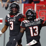 
              North Carolina State's Aydan White (3) celebrates his touchdown with teammate Tyler Baker-Williams (13)  following his interception during the first half of an NCAA college football game against Texas Tech in Raleigh, N.C., Saturday, Sept. 17, 2022. (AP Photo/Karl B DeBlaker)
            