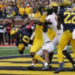 
              Michigan defensive back Mike Sainristil (0) intercepts a 2-point attempt after a Maryland touchdown in the second half of an NCAA college football game in Ann Arbor, Mich., Saturday, Sept. 24, 2022. (AP Photo/Paul Sancya)
            