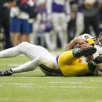 
              Green Bay Packers quarterback Aaron Rodgers is sacked by Minnesota Vikings linebacker Danielle Hunter, rear, during the second half of an NFL football game, Sunday, Sept. 11, 2022, in Minneapolis. (AP Photo/Abbie Parr)
            