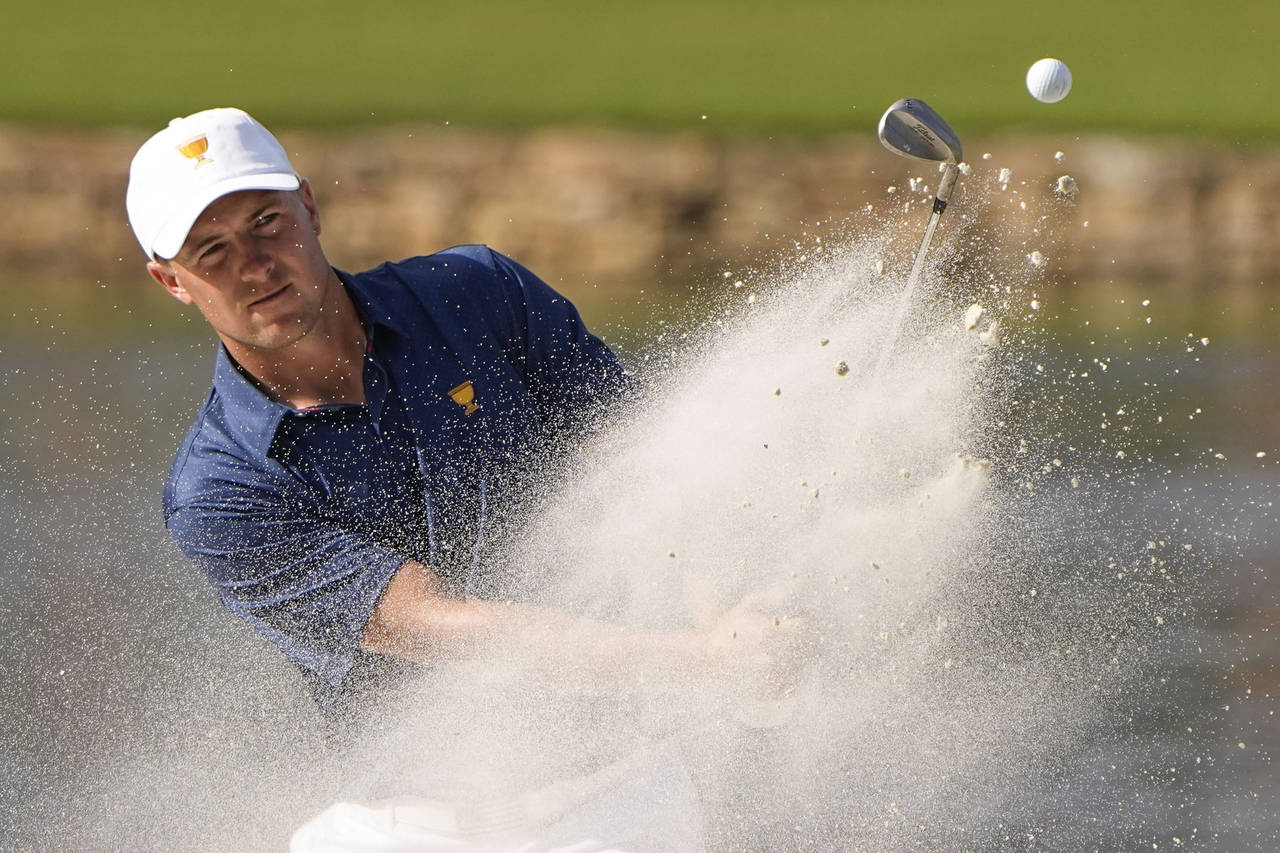 Jordan Spieth hits out of bunker on the 14th hole during their fourball match at the Presidents Cup...