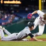 
              Miami Marlins' Joey Wendle, left, cannot beat Philadelphia Phillies pitcher Bailey Falter to first base on a ground out during the sixth inning of a baseball game, Wednesday, Sept. 7, 2022, in Philadelphia. (AP Photo/Matt Slocum)
            