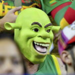 
              A Lithuanian fan wearing a Shrek mask watches the FIBA EuroBasket 2022 group B stage match between Slovenia and Lithuania in Cologne, Germany, Thursday, Sept. 1, 2022. (Zsolt Czegledi/MTI via AP)
            