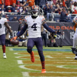 
              Chicago Bears safety Eddie Jackson (4) celebrates after intercepting a pass in the end zone against the Houston Texans during the first half of an NFL football game Sunday, Sept. 25, 2022, in Chicago. (AP Photo/Nam Y. Huh)
            