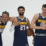 
              From left to right, Denver Nuggets forward Aaron Gordon, guard Jamal Murray and center Nikola Jokic joke around while being photographed during the NBA basketball team's Media Day, Monday, Sept. 26, 2022, in Denver. (AP Photo/David Zalubowski)
            