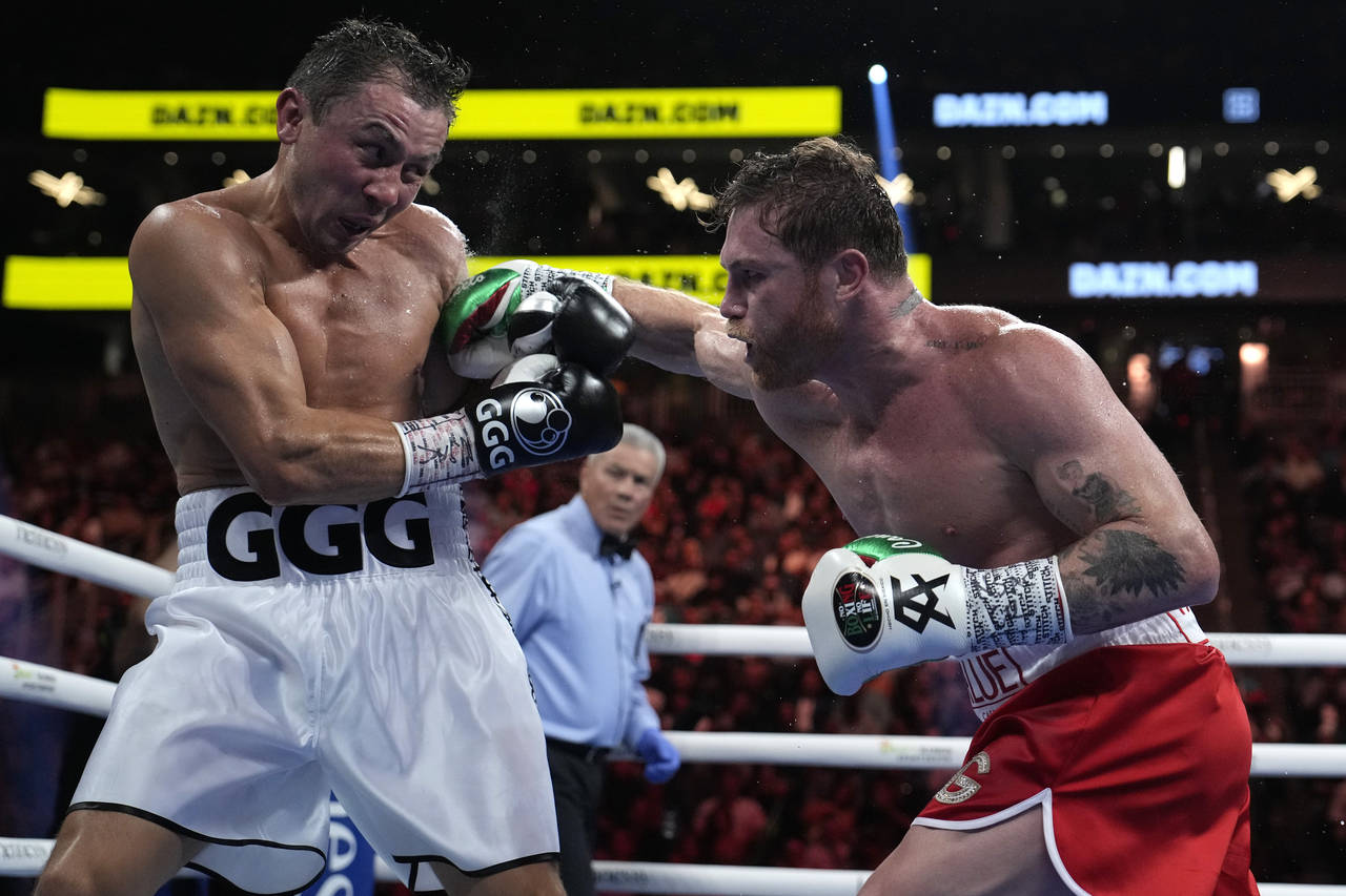 Canelo Alvarez, right, fights Gennady Golovkin in a super middleweight title boxing match, Saturday...