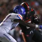
              Oregon State running back Damien Martinez (6) is tackled by Boise State cornerback Tyreque Jones (21) during the second half of an NCAA college football game Saturday, Sept. 3, 2022, in Corvallis, Ore. Oregon State won 34-17. (AP Photo/Amanda Loman)
            