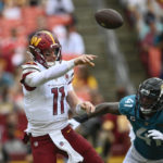 
              Washington Commanders quarterback Carson Wentz (11) throws the ball against Jacksonville Jaguars linebacker Josh Allen (41) during the second half of an NFL football game, Sunday, Sept. 11, 2022, in Landover, Md. (AP Photo/Nick Wass)
            