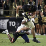 
              Purdue tight end Payne Durham, top, is tackled by Florida Atlantic safety Armani-Eli Adams (30) during an NCAA college football game Saturday, Sept. 24, 2022, in West Lafayette, Ind. (Alex Martin/Journal & Courier via AP)
            