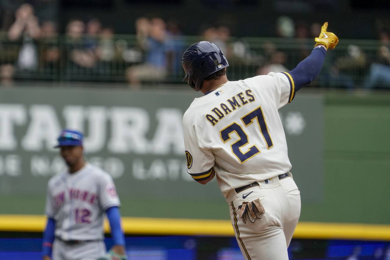 Milwaukee Brewers' Willy Adames reacts after hitting a home run during the sixth inning of a baseba...