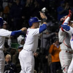 
              Chicago Cubs' Christopher Morel, right, celebrates his three-run home run off Philadelphia Phillies starting pitcher Aaron Nola with Alfonso Rivas and Yan Gomes during the fifth inning of a baseball game Wednesday, Sept. 28, 2022, in Chicago. (AP Photo/Charles Rex Arbogast)
            