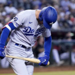 
              Los Angeles Dodgers' Cody Bellinger tries to break his bat as he flies out during the fourth inning of the team's baseball game against the Arizona Diamondbacks in Phoenix, Wednesday, Sept. 14, 2022. (AP Photo/Ross D. Franklin)
            