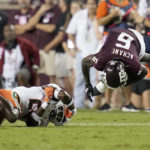 
              Texas A&M running back Devon Achane (6) is upended by Miami safety Kamren Kinchens (24) during the second quarter of an NCAA college football game Saturday, Sept. 17, 2022, in College Station, Texas. (AP Photo/Sam Craft)
            