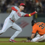 
              Philadelphia Phillies shortstop Bryson Stott, left, catches the throw from first baseman Rhys Hoskins as San Francisco Giants' Andrew Knapp (33) slides safely at second on a groundout by LaMonte Wade Jr. during the fourth inning of a baseball game in San Francisco, Friday, Sept. 2, 2022. (AP Photo/Godofredo A. Vásquez)
            