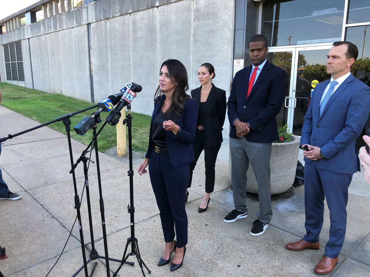 Attorney Alexandra Benevento, center, speaks with reporters during a news conference announcing a c...