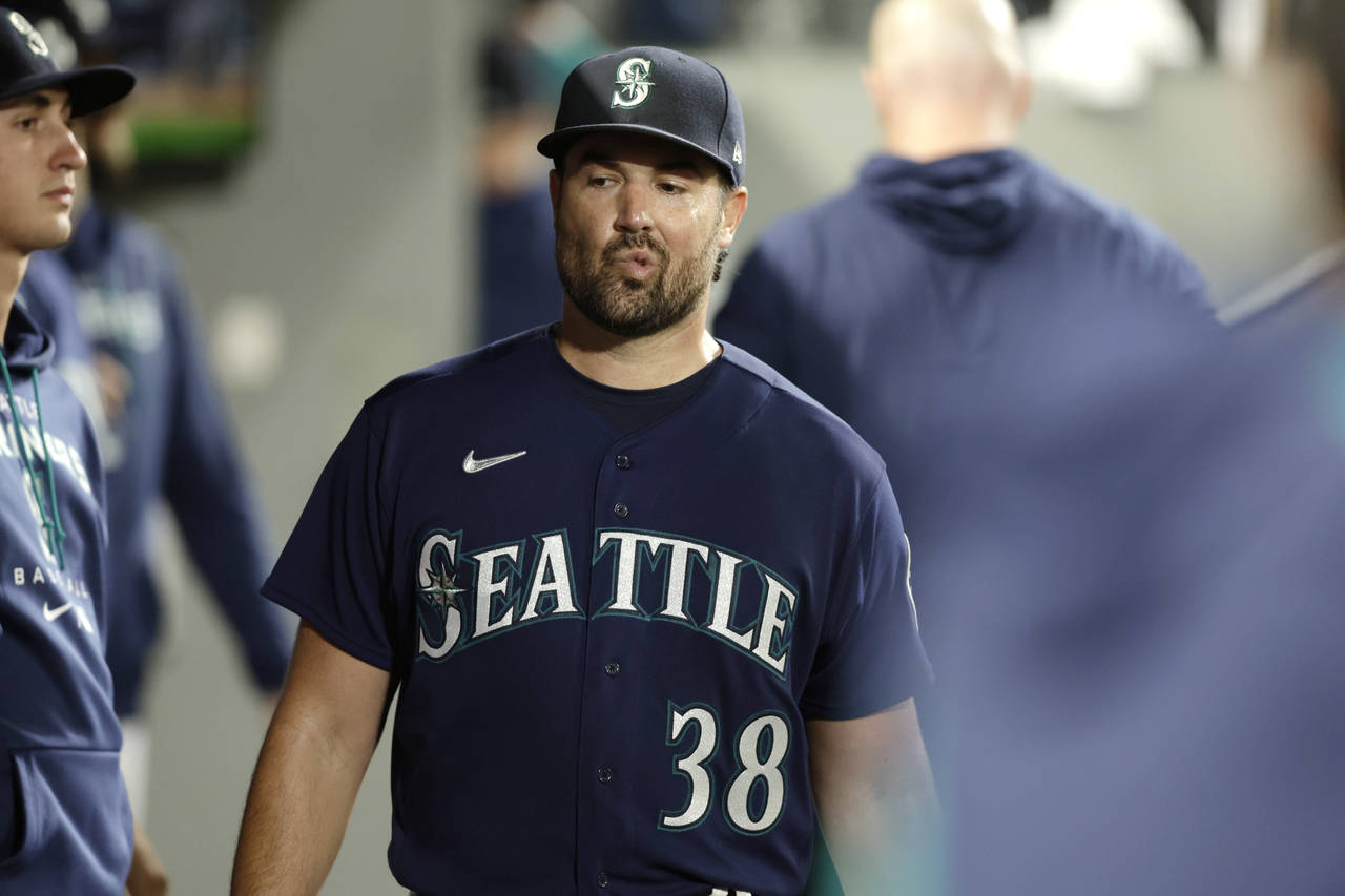 Seattle Mariners starting pitcher Robbie Raywals walks through the dugout after he was pulled from ...