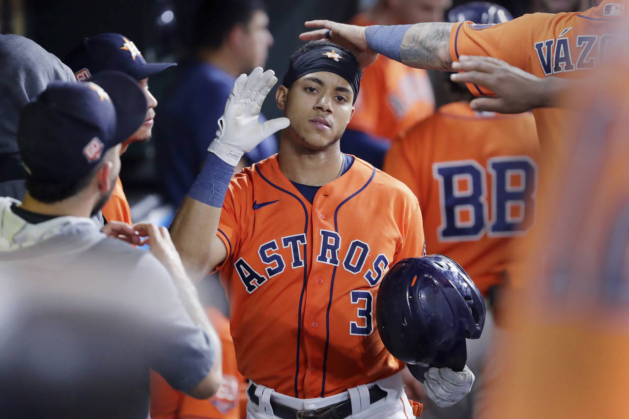 Houston Astros' Jeremy Pena (3) is congratulated in the dugout after his home run against the Los A...
