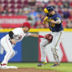 
              Cincinnati Reds second baseman Alejo Lopez (35) tags out Milwaukee Brewers' Omar Narvaez (10) at second base during the third inning of a baseball game Saturday, Sept. 24, 2022, in Cincinnati. (AP Photo/Jeff Dean)
            