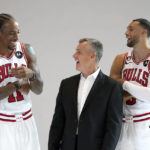 
              Chicago Bulls head coach Billy Donovan, center, DeMar DeRozan (11) and Zach LaVine laugh as they pose for photographers during the Bulls NBA basketball media day Monday, Sept. 26, 2022, in Chicago. (AP Photo/Charles Rex Arbogast)
            