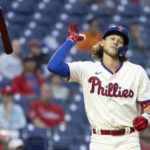 
              Philadelphia Phillies' Alec Bohm throws his bat after striking out in the third inning of a baseball game against the Washington Nationals, Sunday, Sept. 11, 2022, in Philadelphia. (AP Photo/Laurence Kesterson)
            