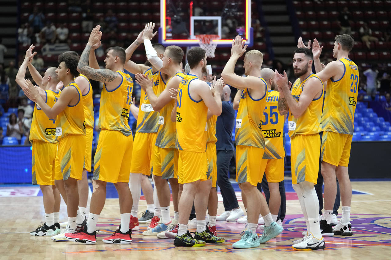 Ukraine's players celebrate at the end of the Eurobasket group C basketball match between Ukraine a...