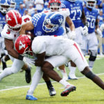 
              Kentucky quarterback Will Levis, center, gets tackled by Youngstown State linebacker Alex Howard (3) and defensive back D'Marco Augustin during the second half of an NCAA college football game in Lexington, Ky., Saturday, Sept. 17, 2022. (AP Photo/Michael Clubb)
            