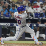 
              New York Mets' Pete Alonso (20) hits a two-run home run in the sixth inning of a baseball game against the Miami Marlins, Friday, Sept. 9, 2022, in Miami. (AP Photo/Marta Lavandier)
            