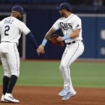 
              Tampa Bay Rays left fielder David Peralta, center, celebrates with teammate Yandy Diaz, left, after they defeated the Boston Red Sox in a baseball game Monday, Sept. 5, 2022, in St. Petersburg, Fla. (AP Photo/Scott Audette)
            