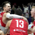 
              Poland's Mateusz Ponitka, left, and his teammates celebrate after the Eurobasket quarter final basketball match between Slovenia and Poland in Berlin, Germany, Wednesday, Sept. 14, 2022. Poland defeated Slovenia by 90-87. (AP Photo/Michael Sohn)
            