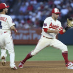 
              Los Angeles Angels shortstop David Fletcher, right, catches the ball from shortstop Andrew Velazquez to make an out at second base during the fourth inning of a baseball game against the Houston Astros on Saturday, Sept. 3, 2022, in Anaheim, Calif. (AP Photo/Raul Romero Jr.)
            