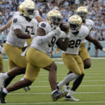 
              Notre Dame defensive lineman Justin Ademilola (9) celebrates with teammates defensive lineman Jayson Ademilola (57) and cornerback TaRiq Bracy (28) after he recovered a fumble during the second half of an NCAA college football game against North Carolina in Chapel Hill, N.C., Saturday, Sept. 24, 2022. (AP Photo/Chris Seward)
            