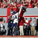 
              North Carolina State's Keyon Lesane (15) catches the ball for a touchdown over Connecticut's Malcolm Bell (14) during the first half of an NCAA college football game in Raleigh, N.C., Saturday, Sept. 24, 2022. (AP Photo/Karl B DeBlaker)
            