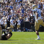 
              UCLA running back Zach Charbonnet, right, runs backwards into the end zone for a touchdown past Colorado defensive end Chance Main in the first half of an NCAA college football game Saturday, Sept. 24, 2022, in Boulder, Colo. (AP Photo/David Zalubowski)
            