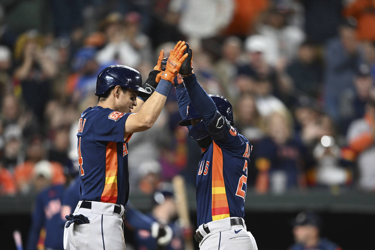 Houston Astros' Jose Altuve, right, celebrates his two-run home run with Maurico Dubon in the third...