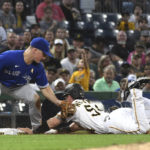 
              Toronto Blue Jays third baseman Matt Chapman, left, tags out Pittsburgh Pirates' Tyler Heineman, right, after taking the throw from catcher Alejandro Kirk during the first inning of a baseball game, Friday, Sept. 2, 2022, in Pittsburgh. (AP Photo/Philip G. Pavely)
            