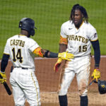 
              Pittsburgh Pirates' Oneil Cruz (15) is greeted by Rodolfo Castro after scoring on a single by Bryan Reynolds off New York Mets starting pitcher Taijuan Walker during the fifth inning of a baseball game in Pittsburgh, Tuesday, Sept. 6, 2022. (AP Photo/Gene J. Puskar)
            