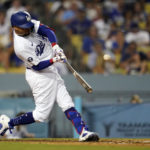 
              Los Angeles Dodgers' Mookie Betts connects for a three-run home run during the fourth inning of a baseball game against the San Diego Padres, Saturday, Sept. 3, 2022, in Los Angeles. (AP Photo/Marcio Jose Sanchez)
            