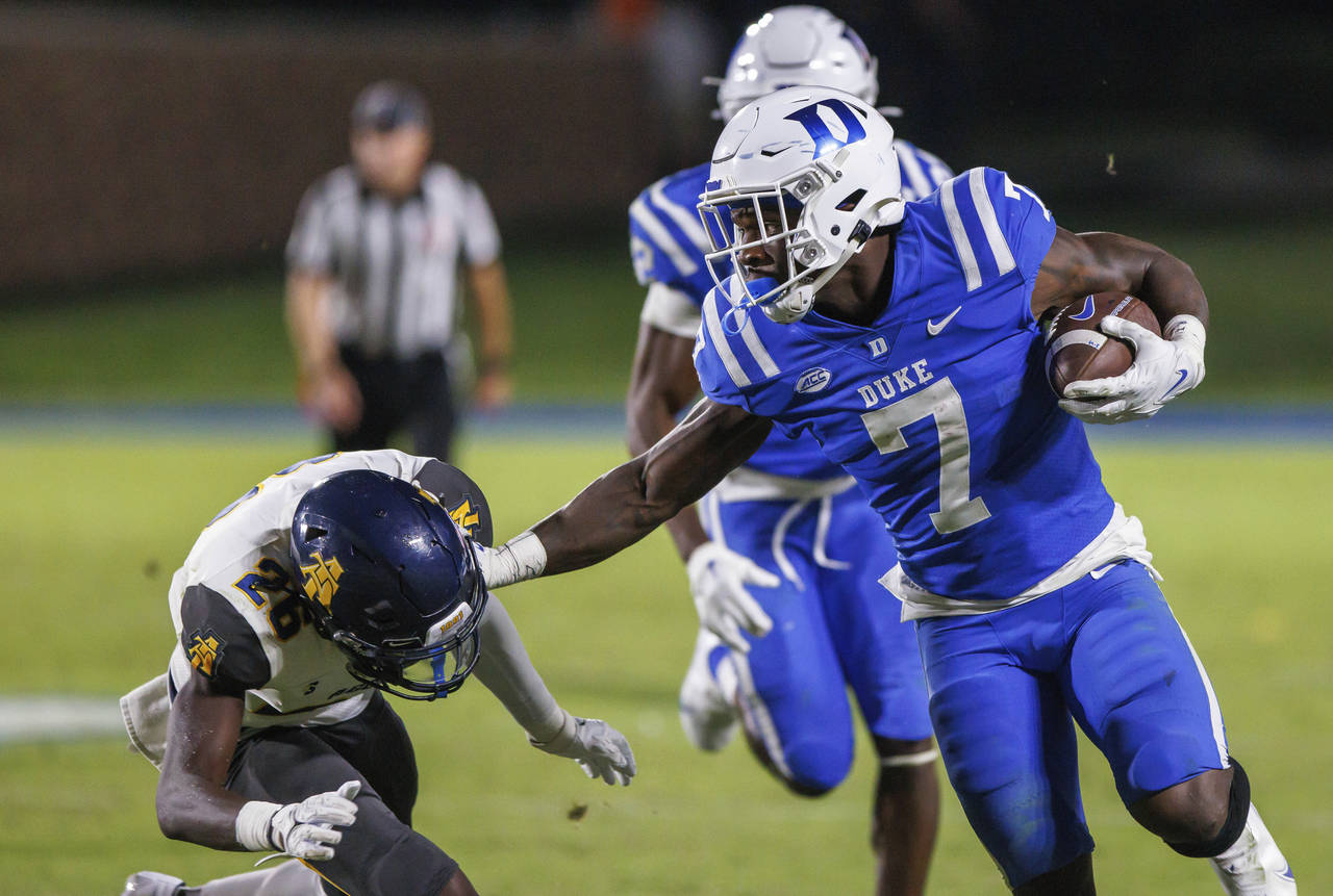 Duke's Jordan Waters (7) carries the ball past North Carolina A&T's Ty Williams Jr. (26) during the...